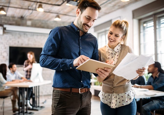Two Insurance Brokers using a Tablet